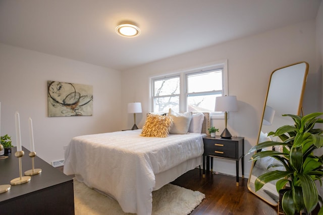 bedroom with dark hardwood / wood-style flooring