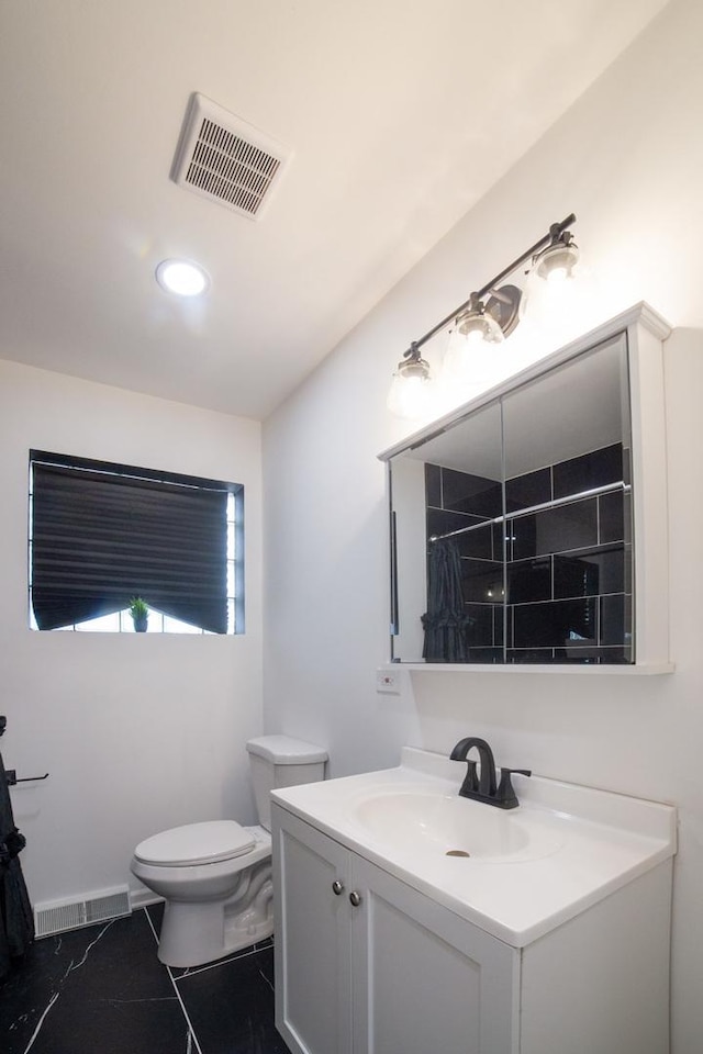 bathroom featuring a shower with shower curtain, tile patterned floors, vanity, and toilet