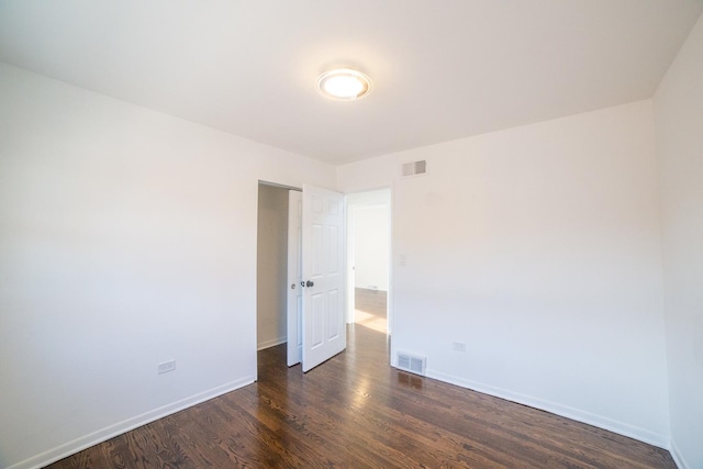 unfurnished room featuring dark hardwood / wood-style floors