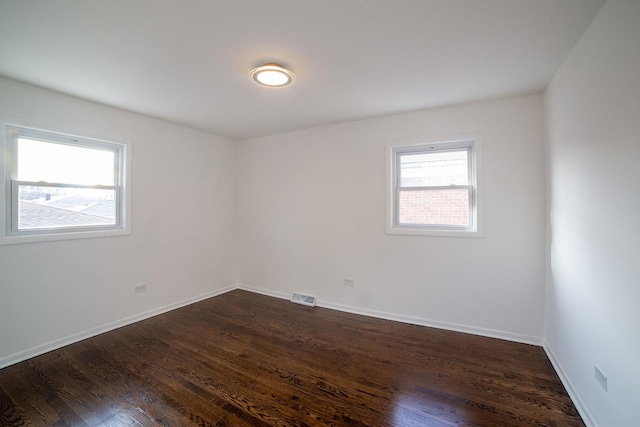 unfurnished room featuring dark hardwood / wood-style flooring