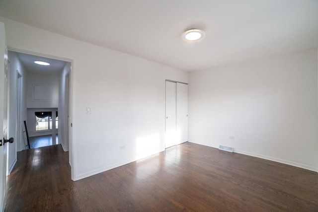 empty room featuring dark hardwood / wood-style flooring