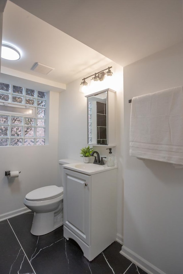 bathroom featuring vanity and toilet