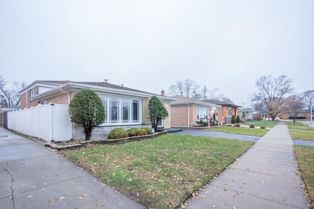 ranch-style home with a front lawn