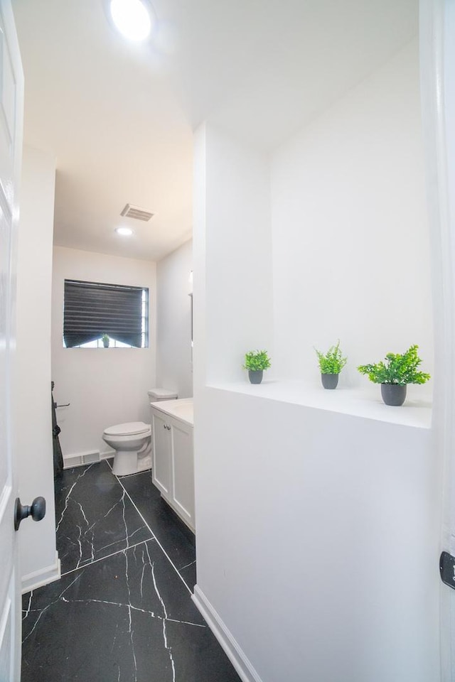 bathroom featuring vanity and toilet