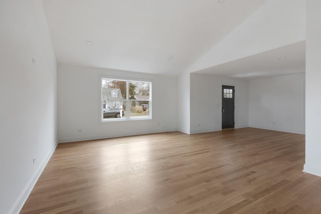 unfurnished living room with light hardwood / wood-style floors and vaulted ceiling