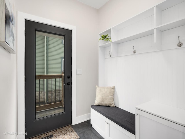 mudroom featuring dark tile patterned flooring