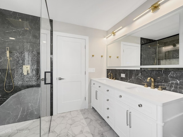 bathroom with a shower with door, vanity, and tasteful backsplash