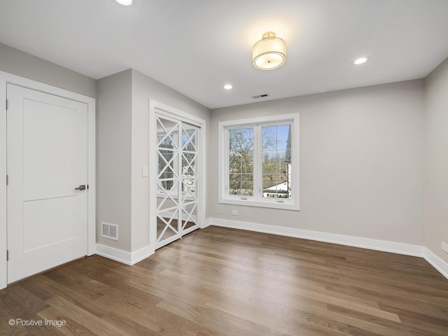 spare room with dark hardwood / wood-style floors