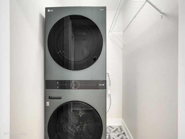 clothes washing area featuring stacked washer / drying machine