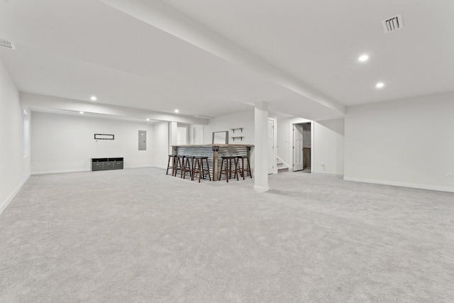 basement featuring electric panel and light carpet