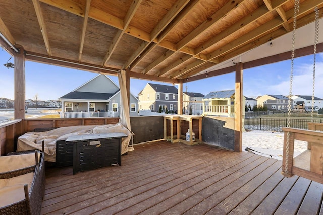 wooden deck with a hot tub