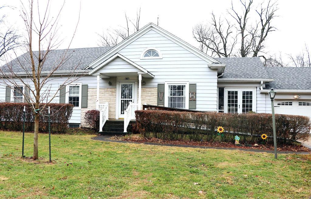 view of front of property with a garage and a front yard