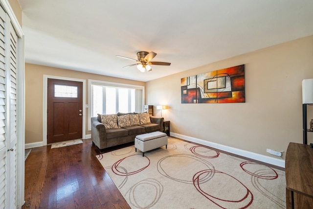 living room with baseboards, wood finished floors, and a ceiling fan