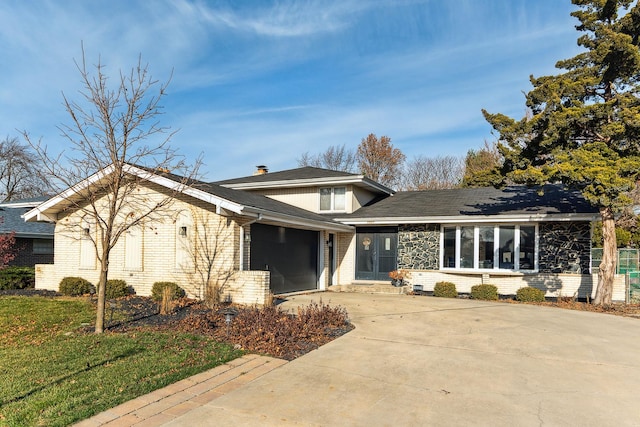 view of front of property with a front yard and a garage