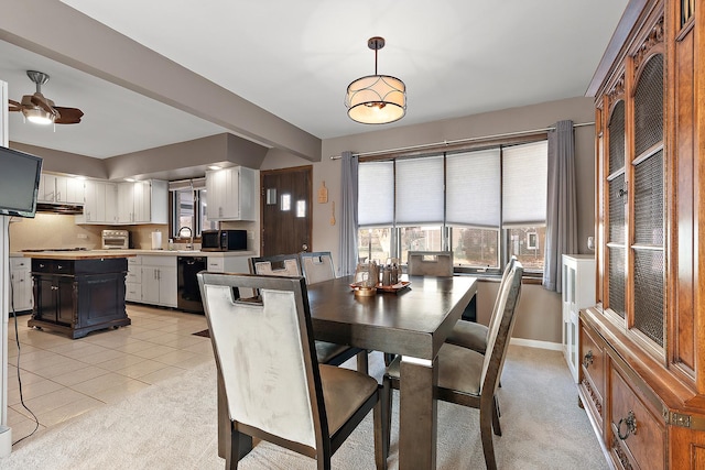 dining room with ceiling fan, sink, and light tile patterned floors