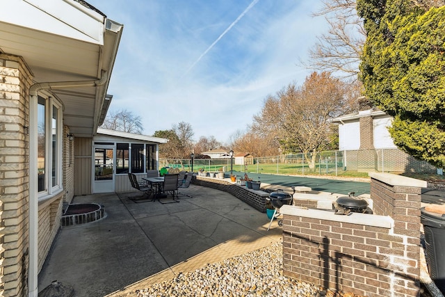 view of patio / terrace featuring a sunroom and a covered pool