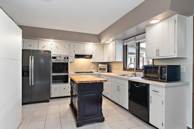 kitchen with sink, a kitchen island, butcher block countertops, white cabinets, and black appliances