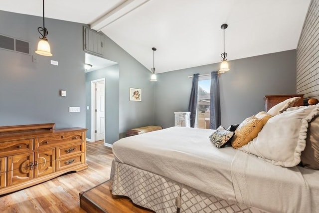 bedroom with hardwood / wood-style floors and lofted ceiling with beams