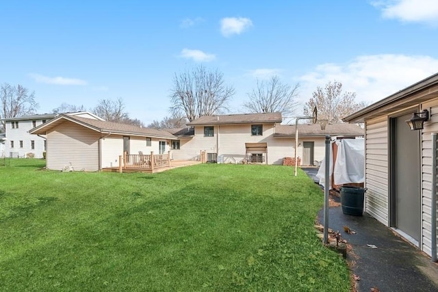 back of property with a lawn, a wooden deck, and central AC