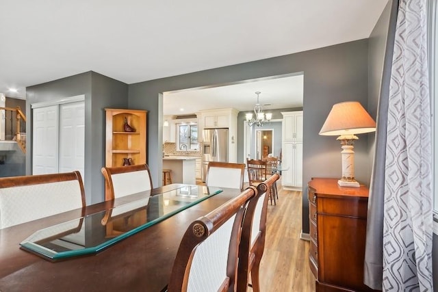 dining room featuring a chandelier and light wood-type flooring