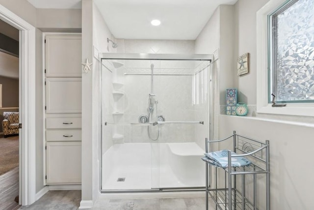 bathroom with a shower with shower door