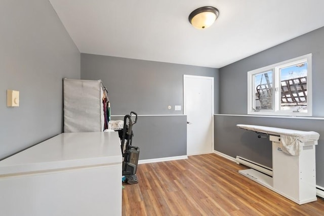 interior space with hardwood / wood-style floors and baseboard heating