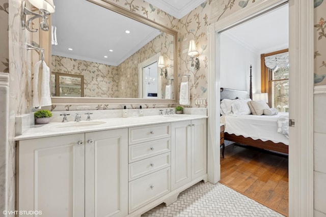 bathroom featuring crown molding, vanity, and hardwood / wood-style floors