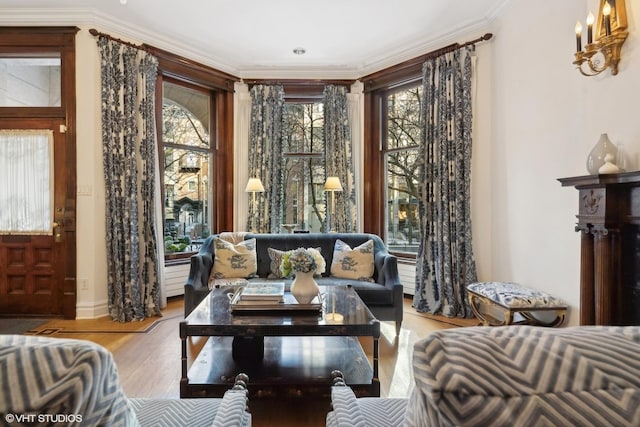 sitting room featuring crown molding and light wood-type flooring