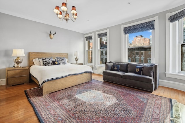 bedroom featuring an inviting chandelier and wood-type flooring