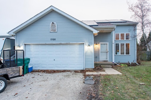 view of front of home with a garage and solar panels