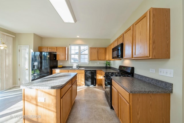 kitchen featuring a center island, black appliances, and sink