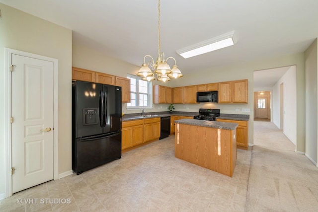 kitchen featuring sink, a center island, hanging light fixtures, an inviting chandelier, and black appliances