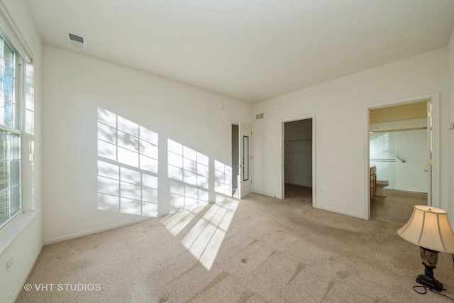 unfurnished room featuring light carpet