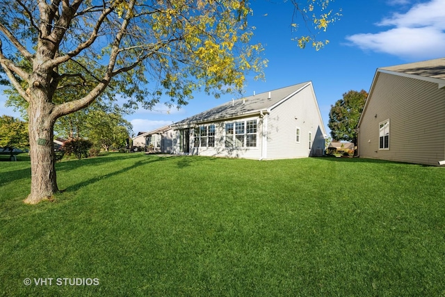 rear view of property with a lawn