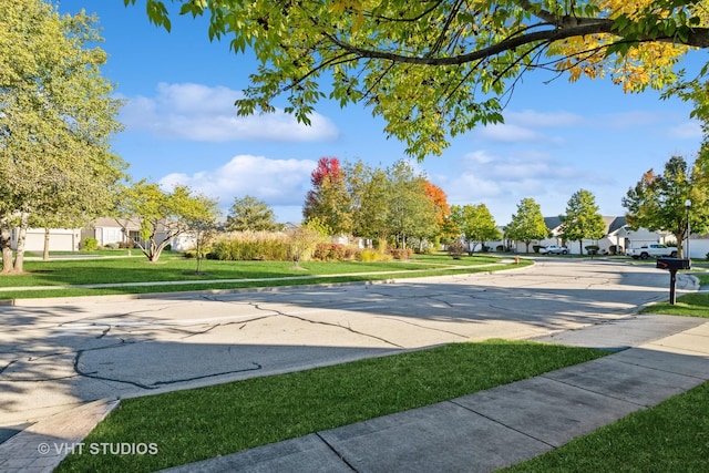 view of home's community with a yard