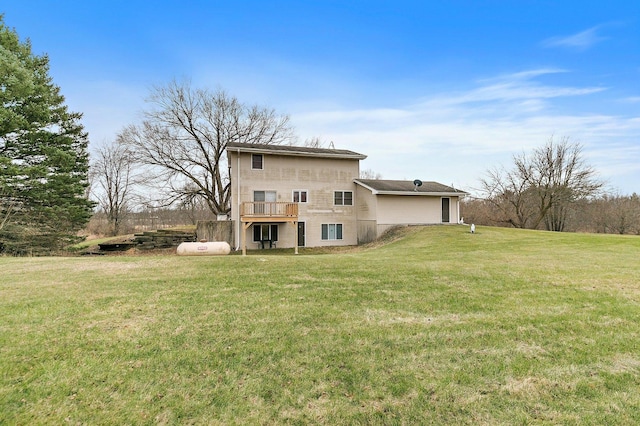 rear view of property featuring a deck and a lawn