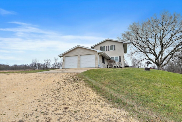 traditional-style house with a garage, concrete driveway, and a front yard