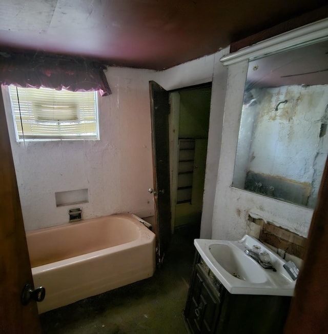 bathroom featuring a tub to relax in and vanity