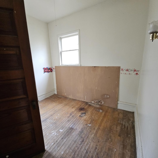 empty room with hardwood / wood-style floors