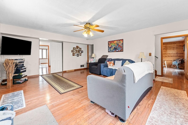 living room featuring ceiling fan and hardwood / wood-style flooring