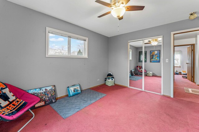 carpeted bedroom featuring a closet and ceiling fan