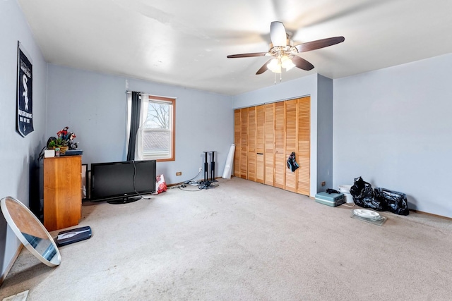 workout room featuring carpet flooring and ceiling fan