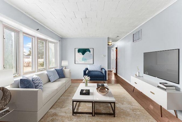 living room with ornamental molding and hardwood / wood-style flooring