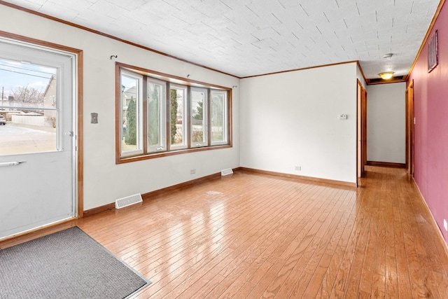 interior space with ornamental molding and light wood-type flooring