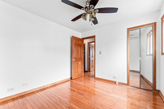 unfurnished bedroom featuring ceiling fan, a closet, and light hardwood / wood-style floors