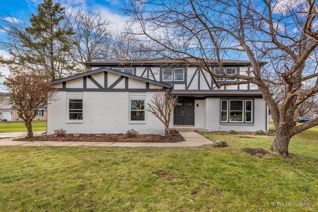 tudor house featuring a front lawn