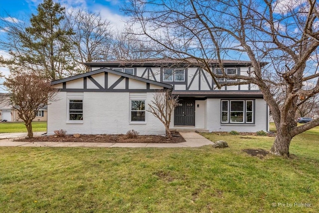 tudor house featuring a front lawn