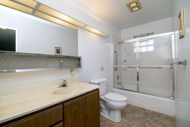 full bathroom featuring vanity, toilet, and bath / shower combo with glass door