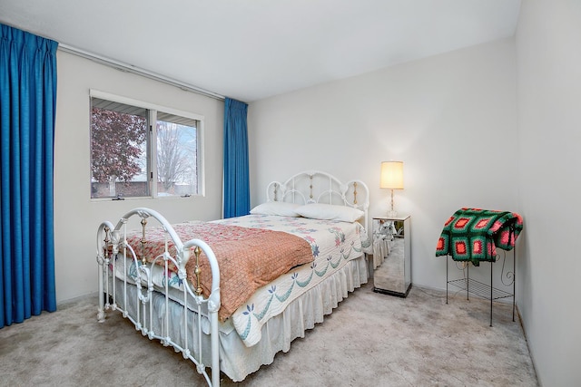 bedroom featuring light carpet