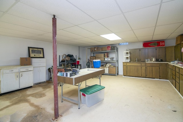 interior space with a paneled ceiling